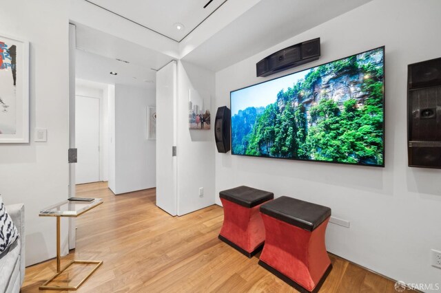 home theater with light wood-style flooring