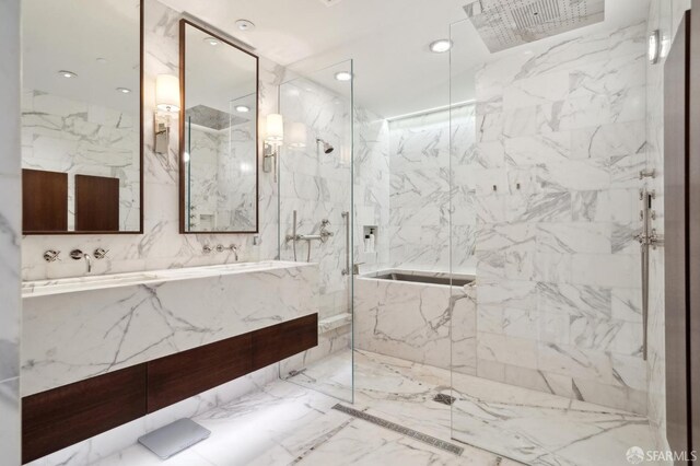 bathroom featuring double vanity, a sink, a marble finish shower, and marble finish floor