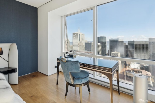 office space with a city view and wood finished floors