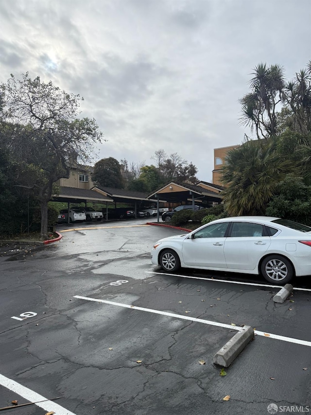 view of parking / parking lot featuring a carport