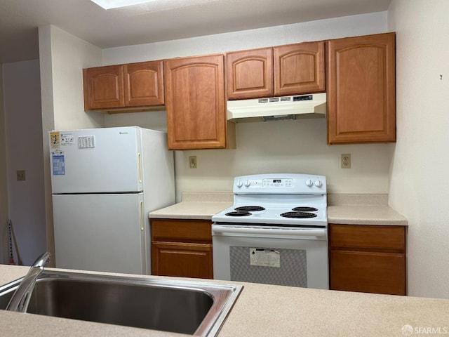 kitchen featuring sink and white appliances