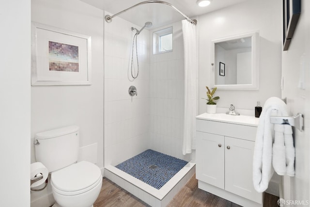 bathroom featuring vanity, hardwood / wood-style flooring, toilet, and a shower with shower curtain