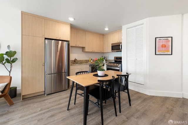 dining room featuring light hardwood / wood-style floors and sink