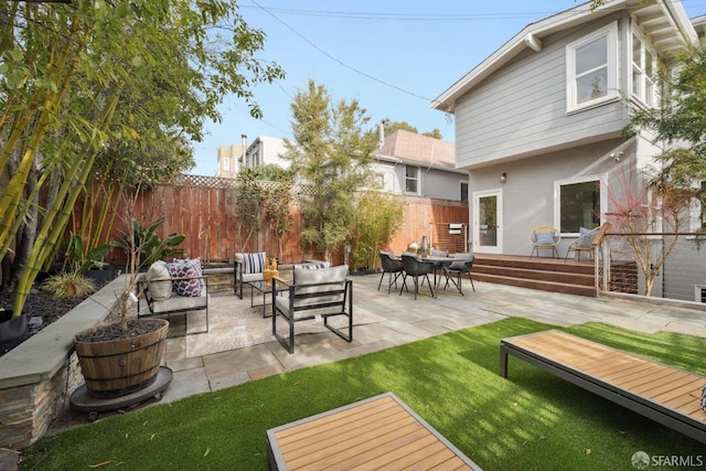 exterior space with an outdoor hangout area and a patio