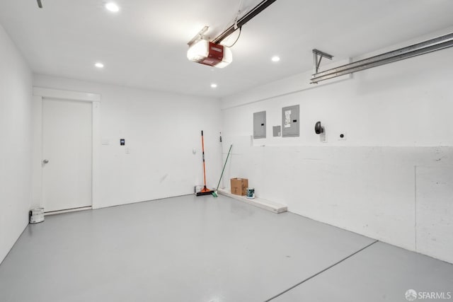 garage with a garage door opener and electric panel