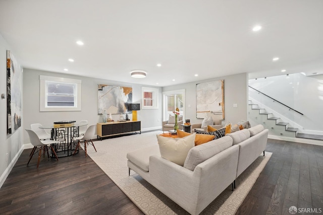 living room featuring dark hardwood / wood-style floors and a wealth of natural light