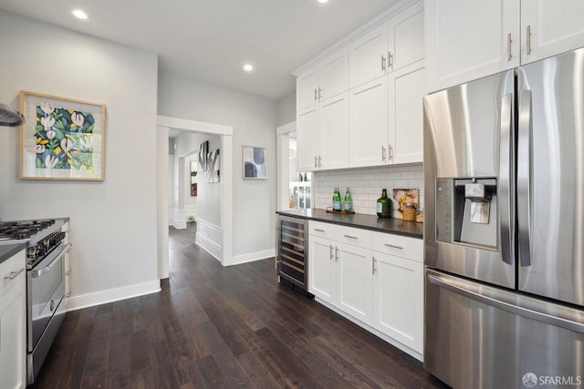 kitchen with dark hardwood / wood-style floors, white cabinets, wine cooler, backsplash, and stainless steel appliances