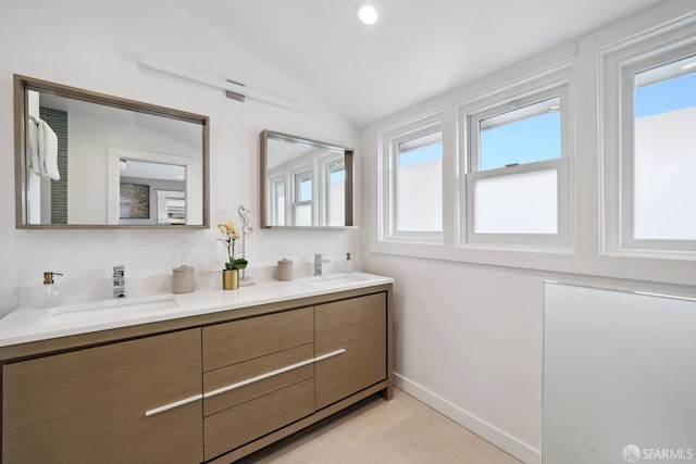 bathroom featuring vanity and lofted ceiling