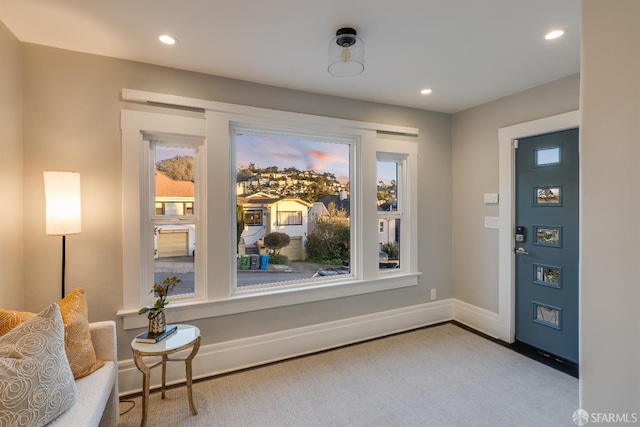 view of carpeted foyer entrance