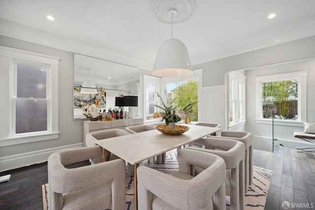 dining space featuring crown molding and dark hardwood / wood-style floors