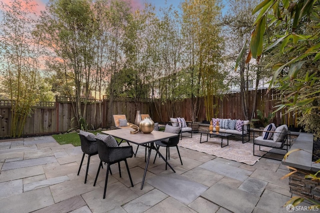 patio terrace at dusk with an outdoor living space