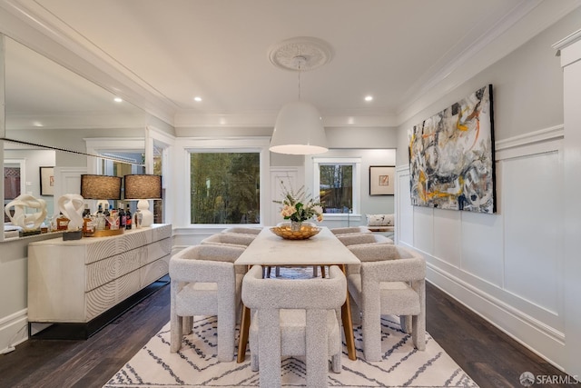 dining room with ornamental molding and dark hardwood / wood-style floors