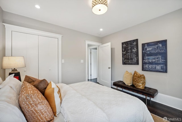 bedroom featuring dark wood-type flooring and a closet