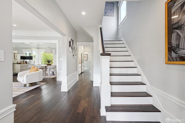 staircase with hardwood / wood-style flooring and crown molding