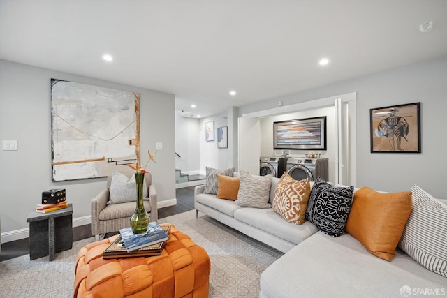 living room featuring independent washer and dryer and light hardwood / wood-style flooring