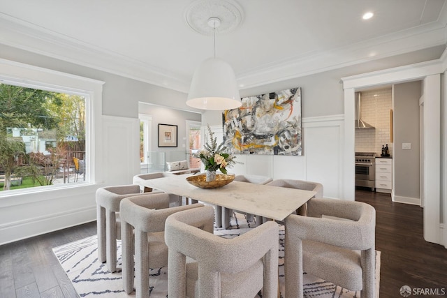 dining space featuring ornamental molding and dark hardwood / wood-style floors