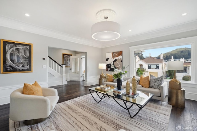 living room featuring ornamental molding and dark hardwood / wood-style flooring