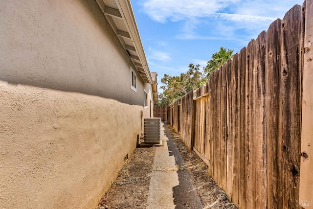 1607 California Dr, Vacaville, CA 95687 - view of side of property featuring stucco siding and a central AC unit