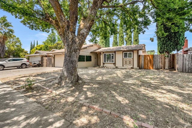 1607 California Dr, Vacaville, CA 95687 - ranch-style house featuring stucco siding, concrete driveway, and an attached garage