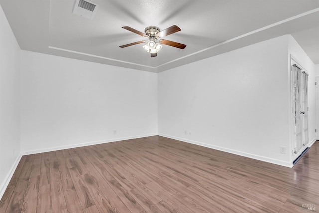 1607 California Dr, Vacaville, CA 95687 - unfurnished room featuring a ceiling fan, wood finished floors, and a tray ceiling