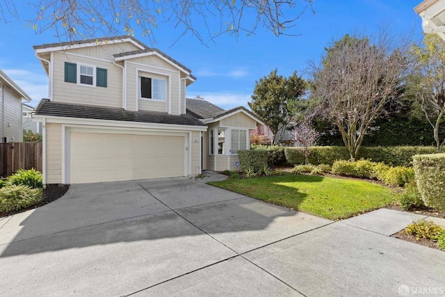 view of front of property featuring an attached garage, fence, driveway, a front lawn, and board and batten siding