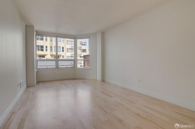 spare room featuring light hardwood / wood-style floors