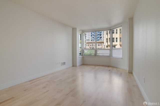 empty room with light hardwood / wood-style floors