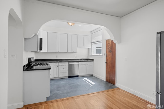59 Collingwood St, San Francisco, CA 94114 - kitchen featuring stainless steel dishwasher, arched walkways, dark countertops, range, and a sink