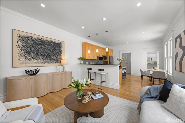 living room featuring recessed lighting, ornamental molding, and light wood-style floors