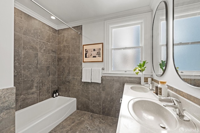 full bath featuring tile walls, crown molding, tub / shower combination, and double vanity