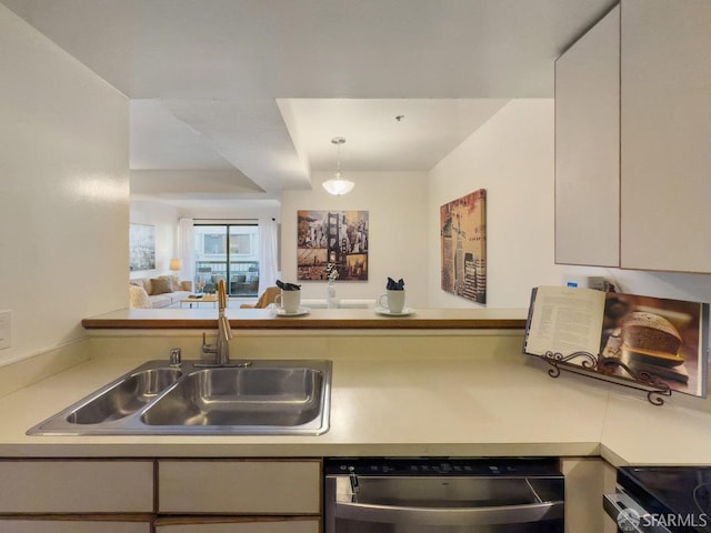 kitchen with white cabinetry, range, dishwasher, and sink