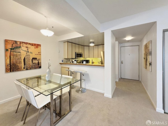 dining room featuring light colored carpet