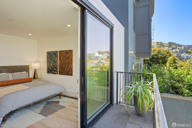 bedroom featuring baseboards, light wood finished floors, access to exterior, and recessed lighting