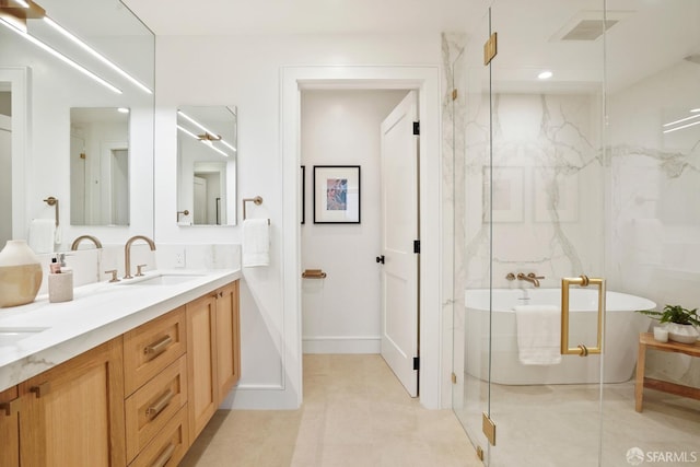 full bath featuring a sink, visible vents, a freestanding bath, a marble finish shower, and double vanity