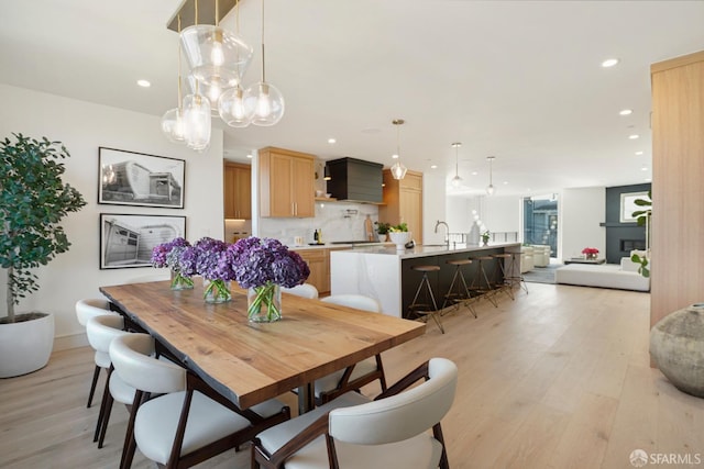dining area featuring light wood finished floors and recessed lighting