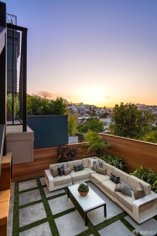 patio terrace at dusk featuring an outdoor living space