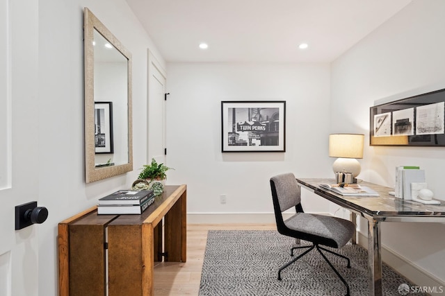 office space featuring light wood finished floors, recessed lighting, and baseboards