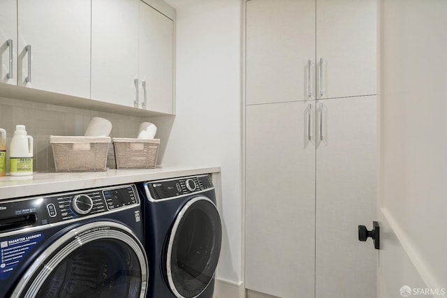 clothes washing area with cabinet space and washing machine and clothes dryer