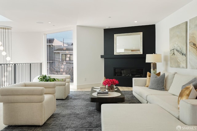 living room with recessed lighting and a glass covered fireplace