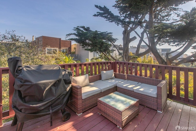 wooden terrace with outdoor lounge area and area for grilling