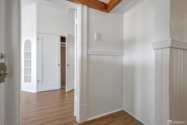 corridor with hardwood / wood-style floors