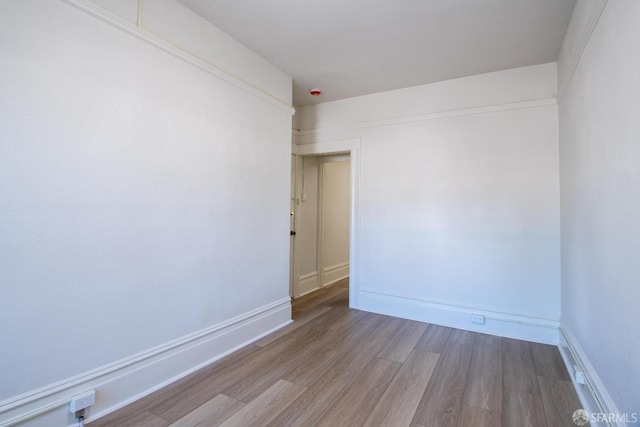 unfurnished room with light wood-type flooring