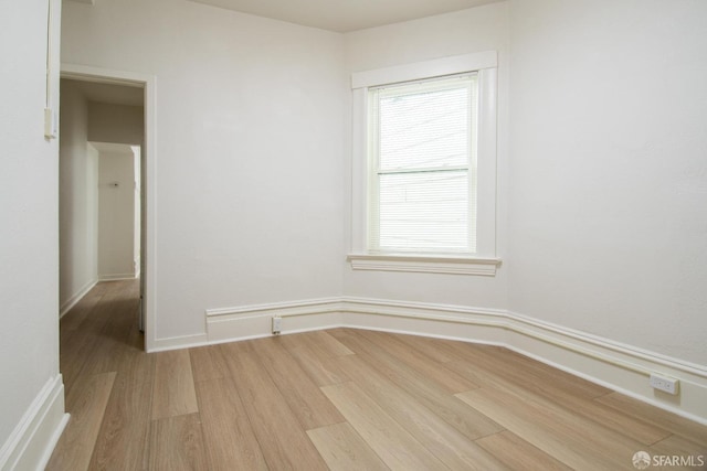 empty room with light hardwood / wood-style flooring