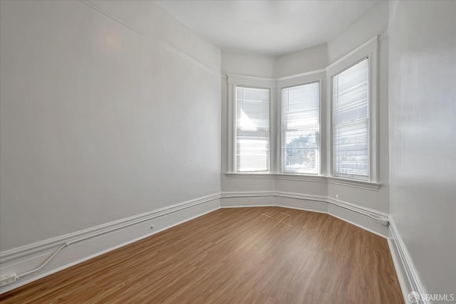 unfurnished room with hardwood / wood-style floors