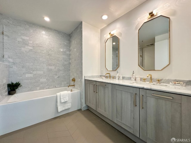 bathroom featuring vanity, a bathtub, and tile patterned flooring