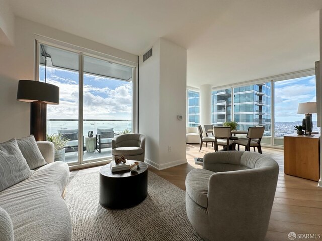 401 Harrison St Unit 48C, San Francisco, CA 94105 - living area featuring visible vents, baseboards, and wood finished floors