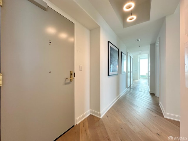 hallway with light hardwood / wood-style floors