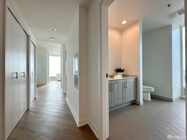 401 Harrison St Unit 48C, San Francisco, CA 94105 - hallway with recessed lighting, baseboards, visible vents, and hardwood / wood-style floors