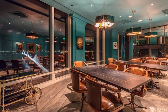 dining area featuring a notable chandelier and light wood-type flooring