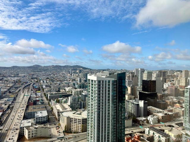 property's view of city featuring a mountain view